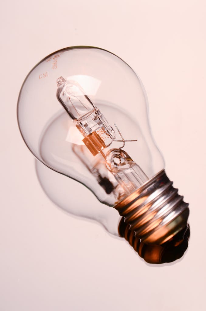 Detailed image of a classic clear incandescent bulb, encapsulating energy and innovation concepts.